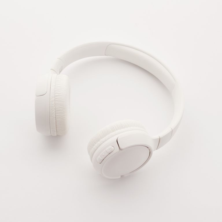 Sleek overhead view of modern white wireless headphones on a clean white background.